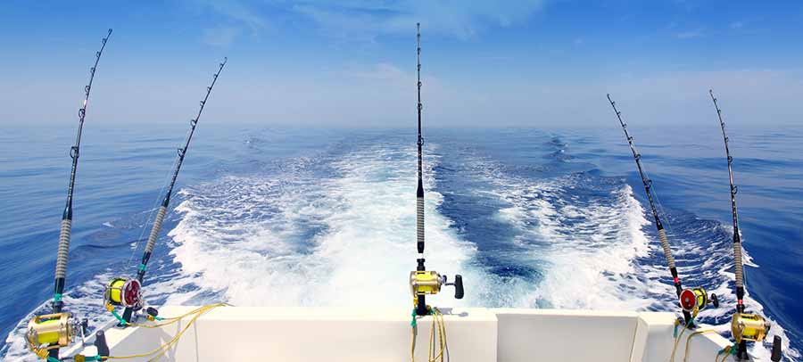 boat trolling the sea with fishing rods and reels