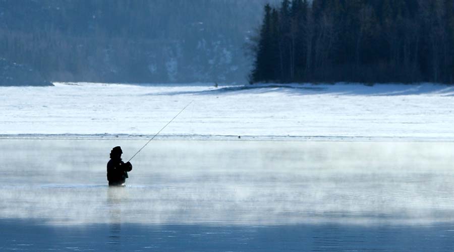 fishing in lake during winter