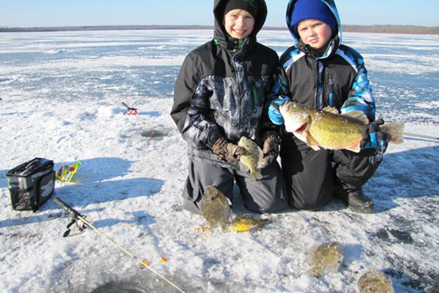 two boy catch largemouth bass ice fishin on tamarac lake