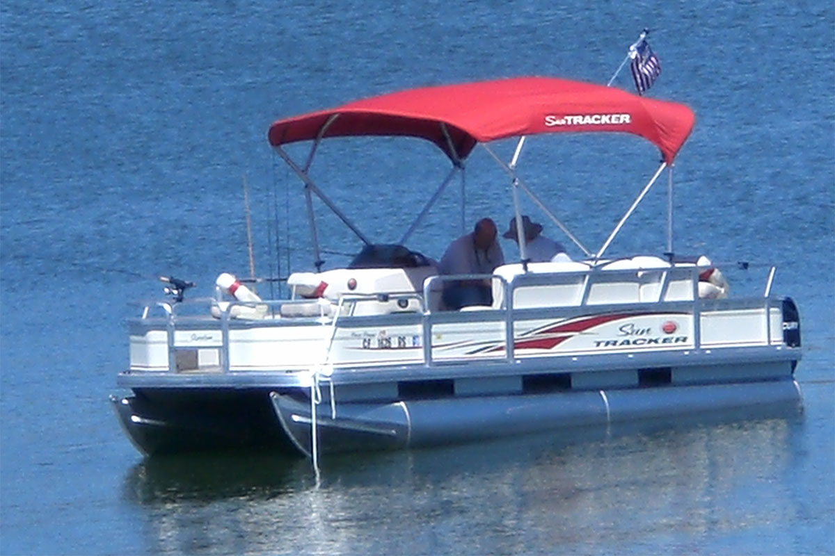 bass buggy pontoon boat with angelers fishing on lake