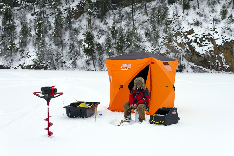 ice fishing on lake with equipement